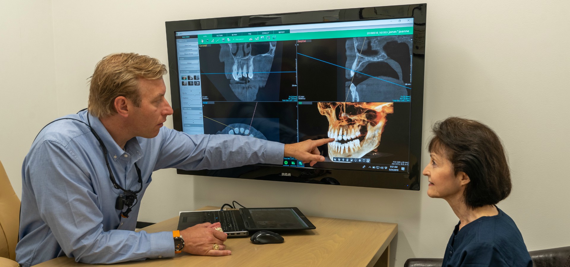 Dr. Bill and staff member examining at patient x-ray.