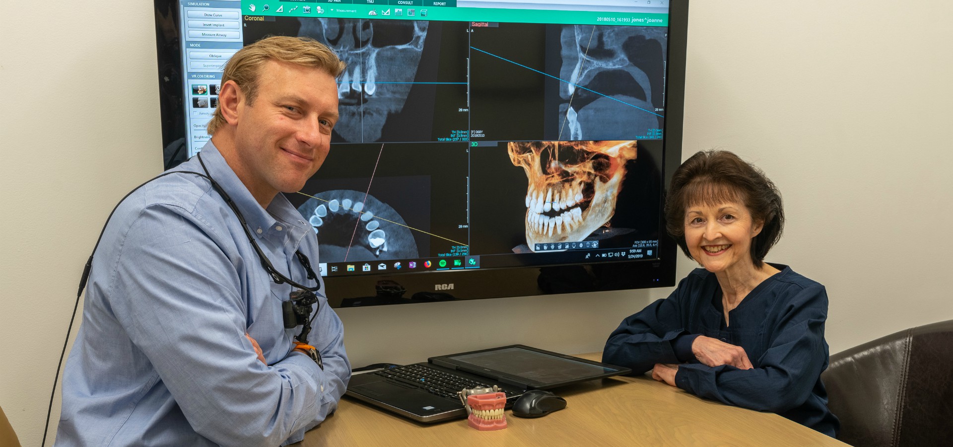 Dr. Argersinger and employee smiling in exam room at Durham DDS.